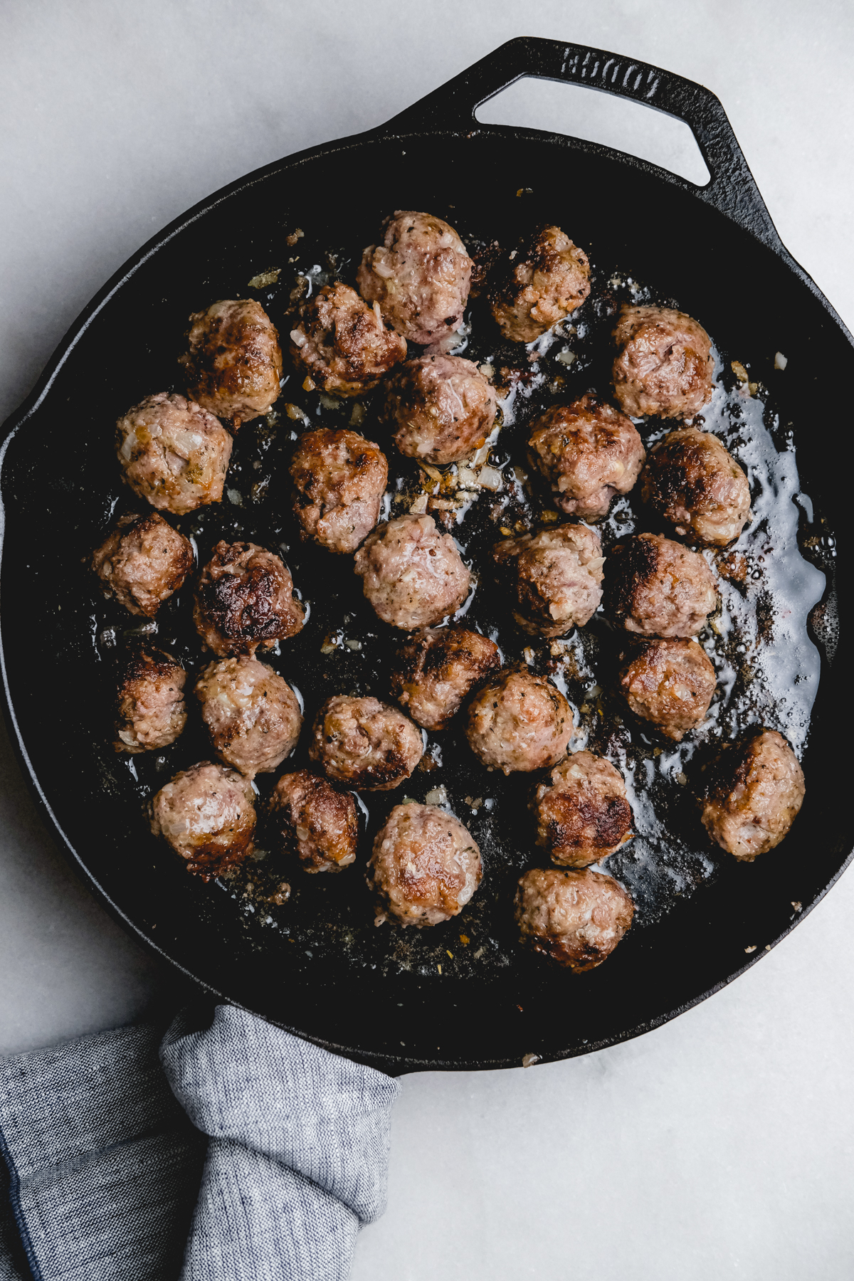 cooked Italian meatballs in a cast iron skillet