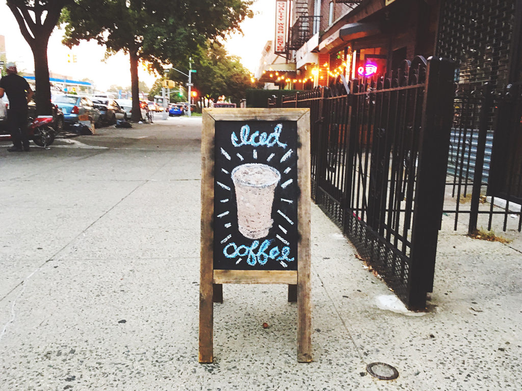 iced coffee shop sign outside of shop in brooklyn