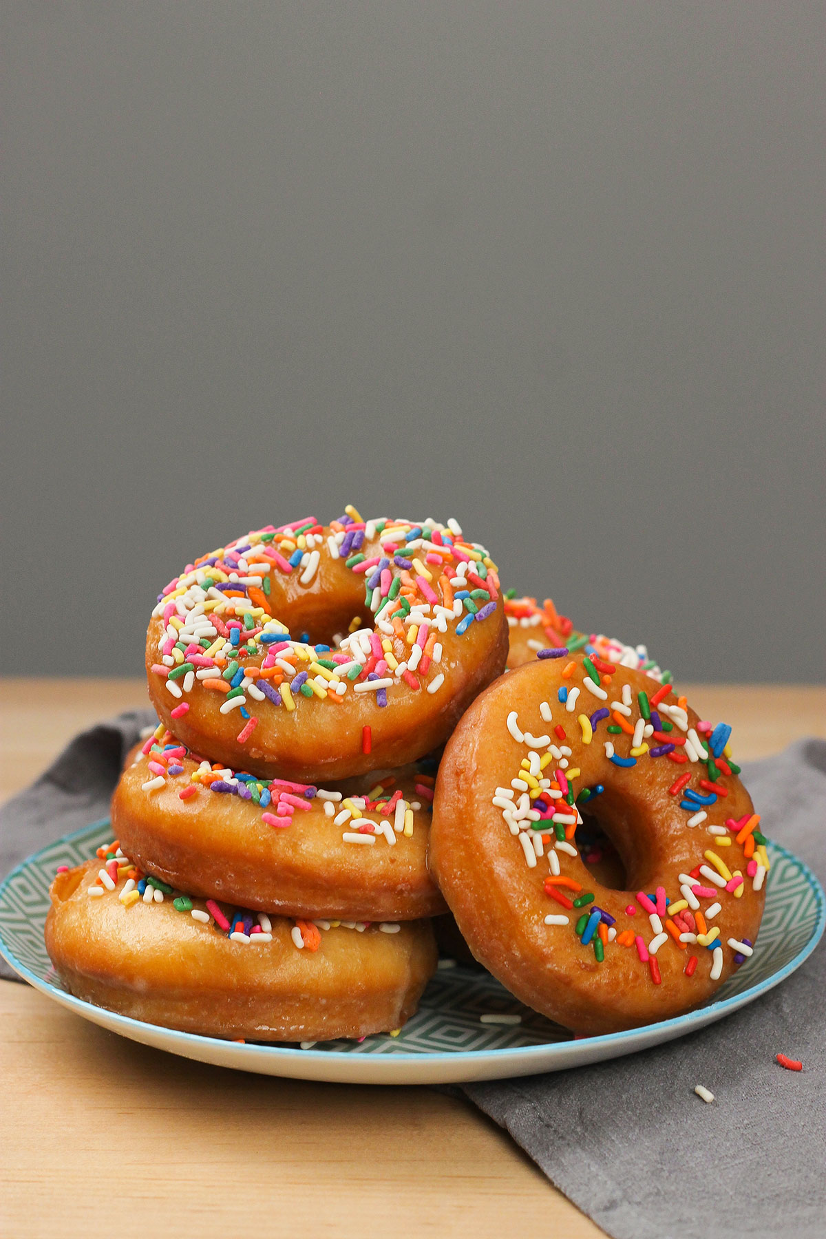 homemade donuts with sprinkles on a plate