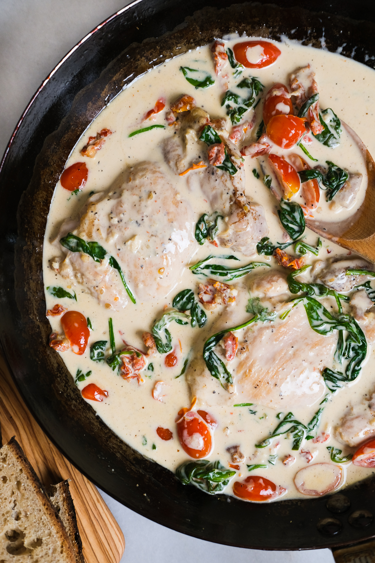creamy tuscan chicken thighs in a pan