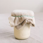 sourdough starter covered with a cloth
