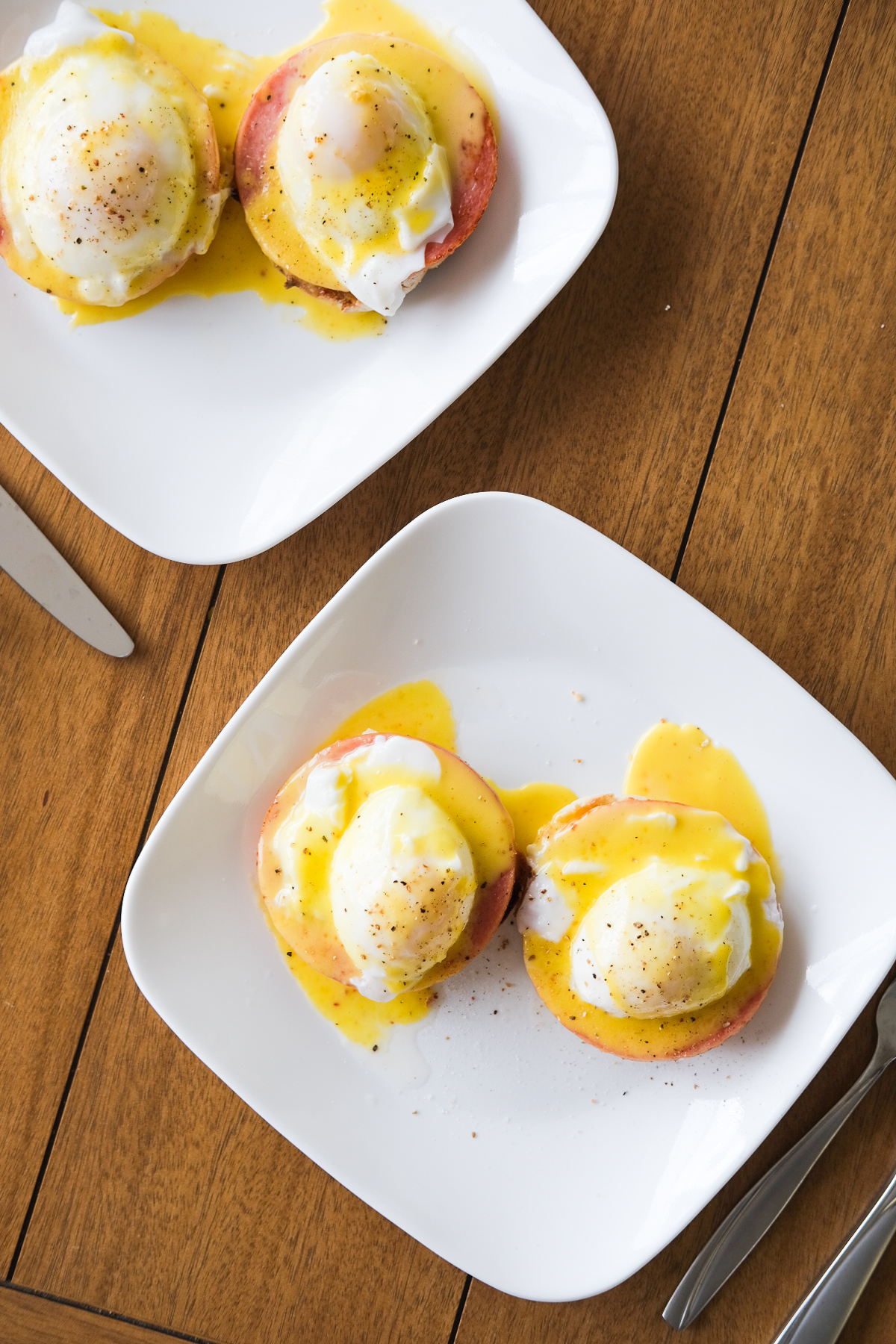 plates of eggs benedict with hollandaise sauce