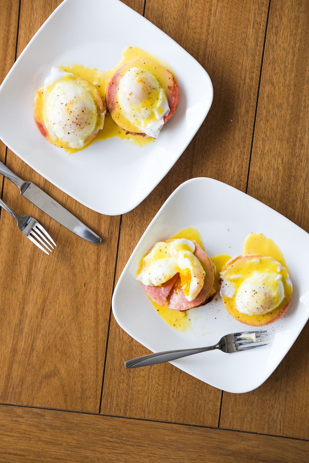 breaking into a plate of eggs benedict