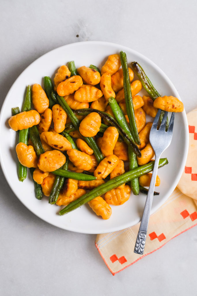 plate of sweet potato gnocchi with green beans