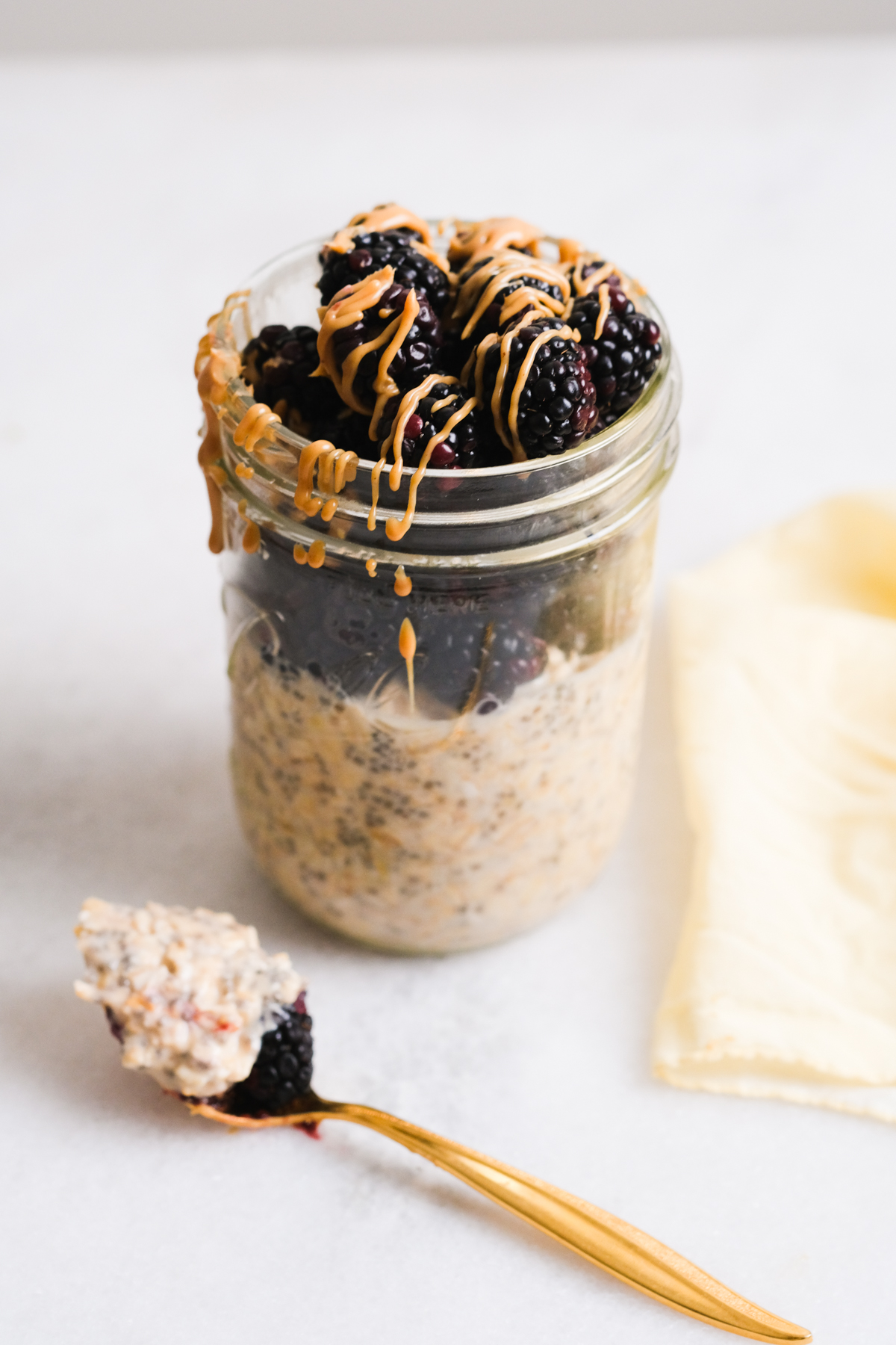 spoonful of peanut butter overnight oats with blackberries