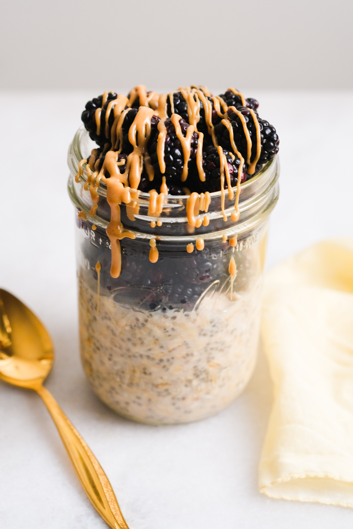 peanut butter overnight oats with berries and peanut butter drizzle