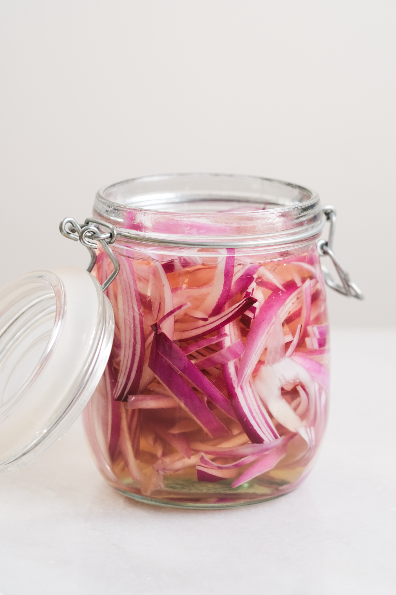 red onions after vinegar base has been poured into a jar for pickling