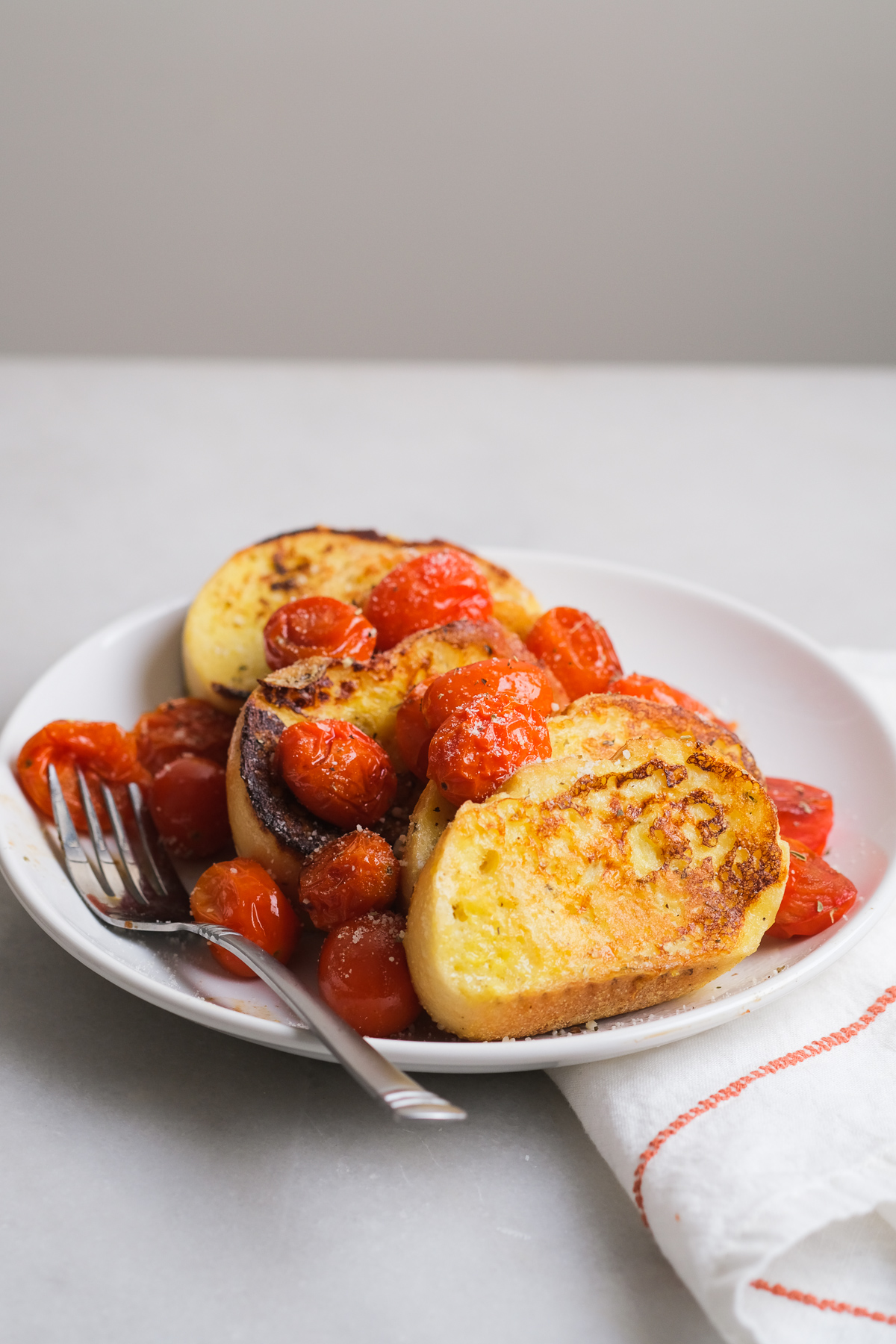 roasted cherry tomatoes on top of savory french toast