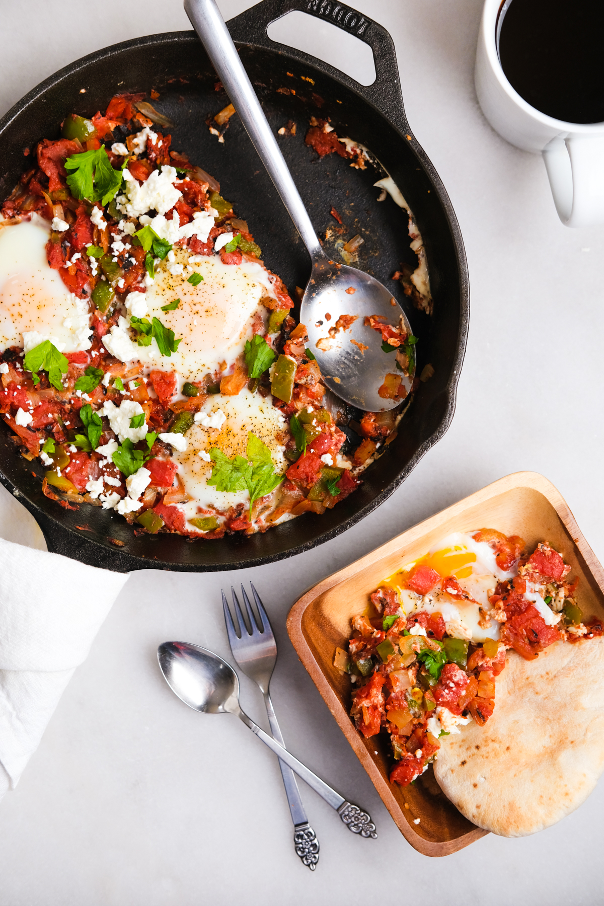 scooping out shakshuka into a bowl