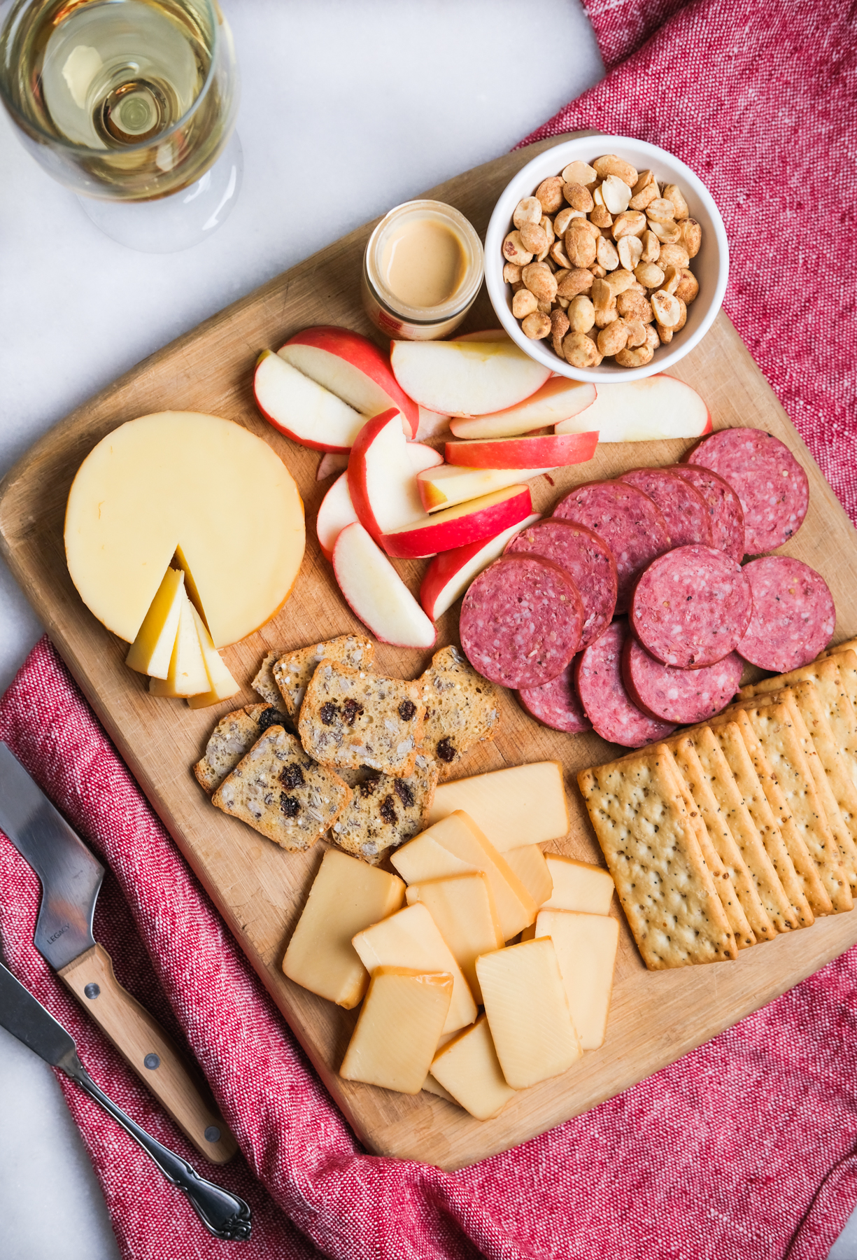 cheese board with meat and apples