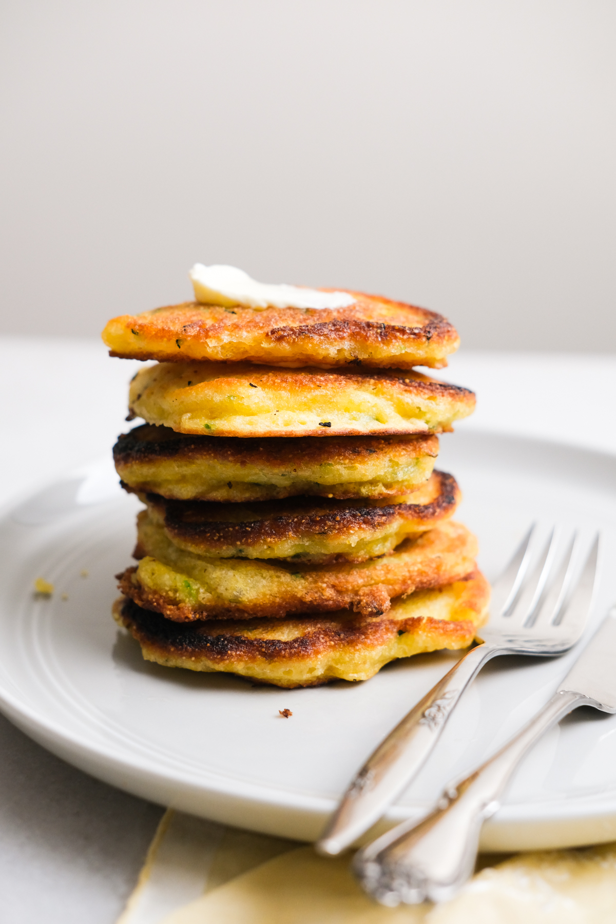 zucchini fritters stacked up on a plate