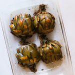 roasted artichokes in a glass dish