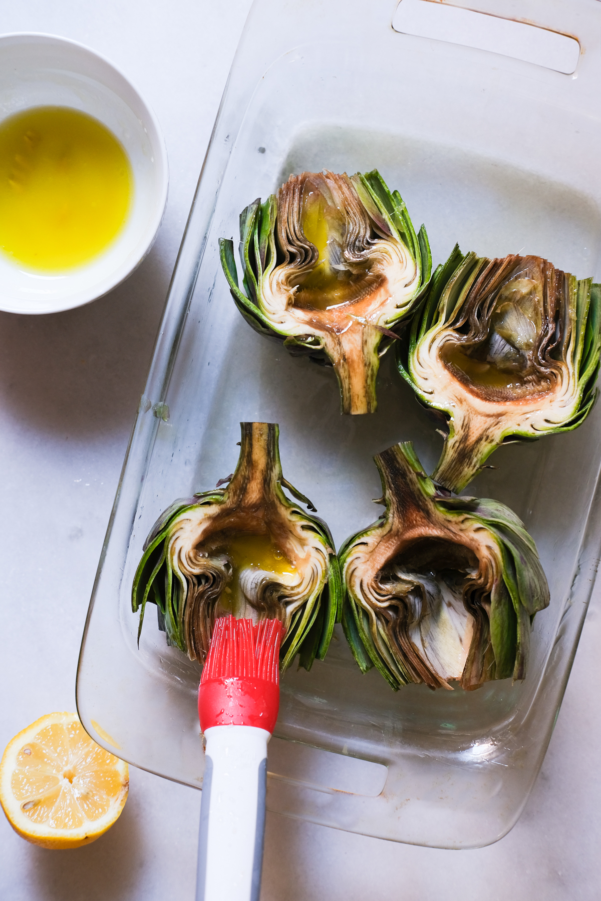 brushing artichokes with lemon and water