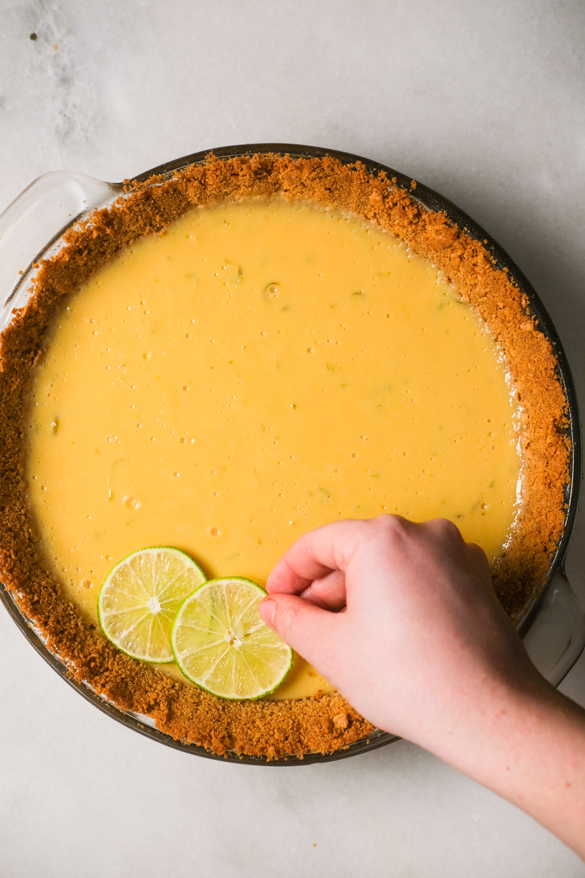 placing lime wheels on a key lime pie