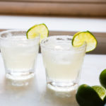 two margaritas with limes