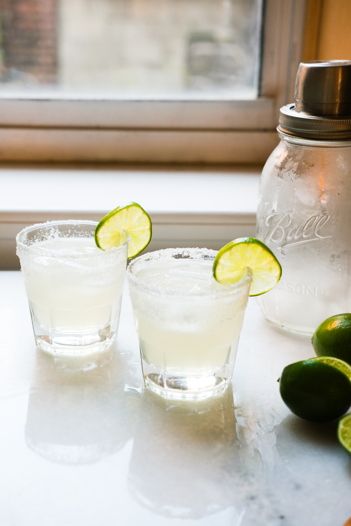 two margaritas with limes