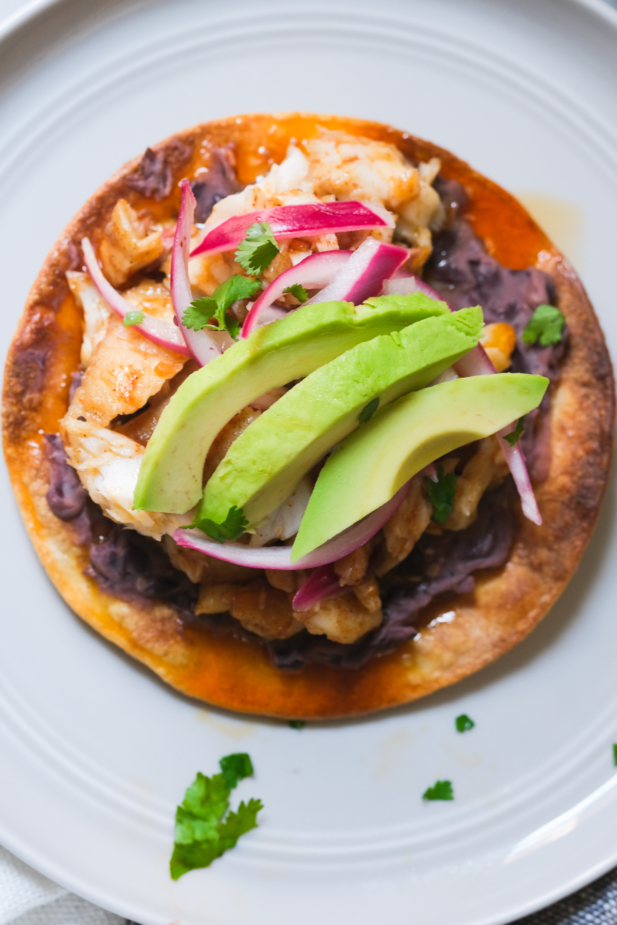 tostada with refried black beans and toppings