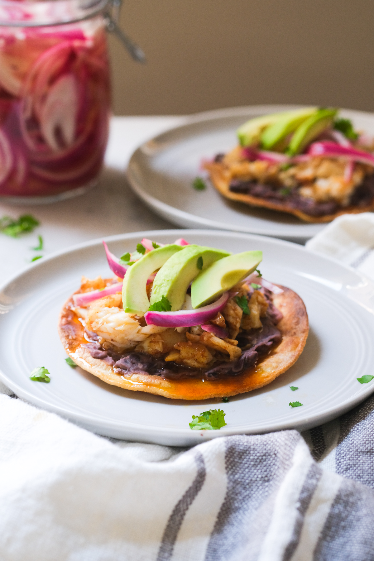 tostadas with black beans and pickled red onions