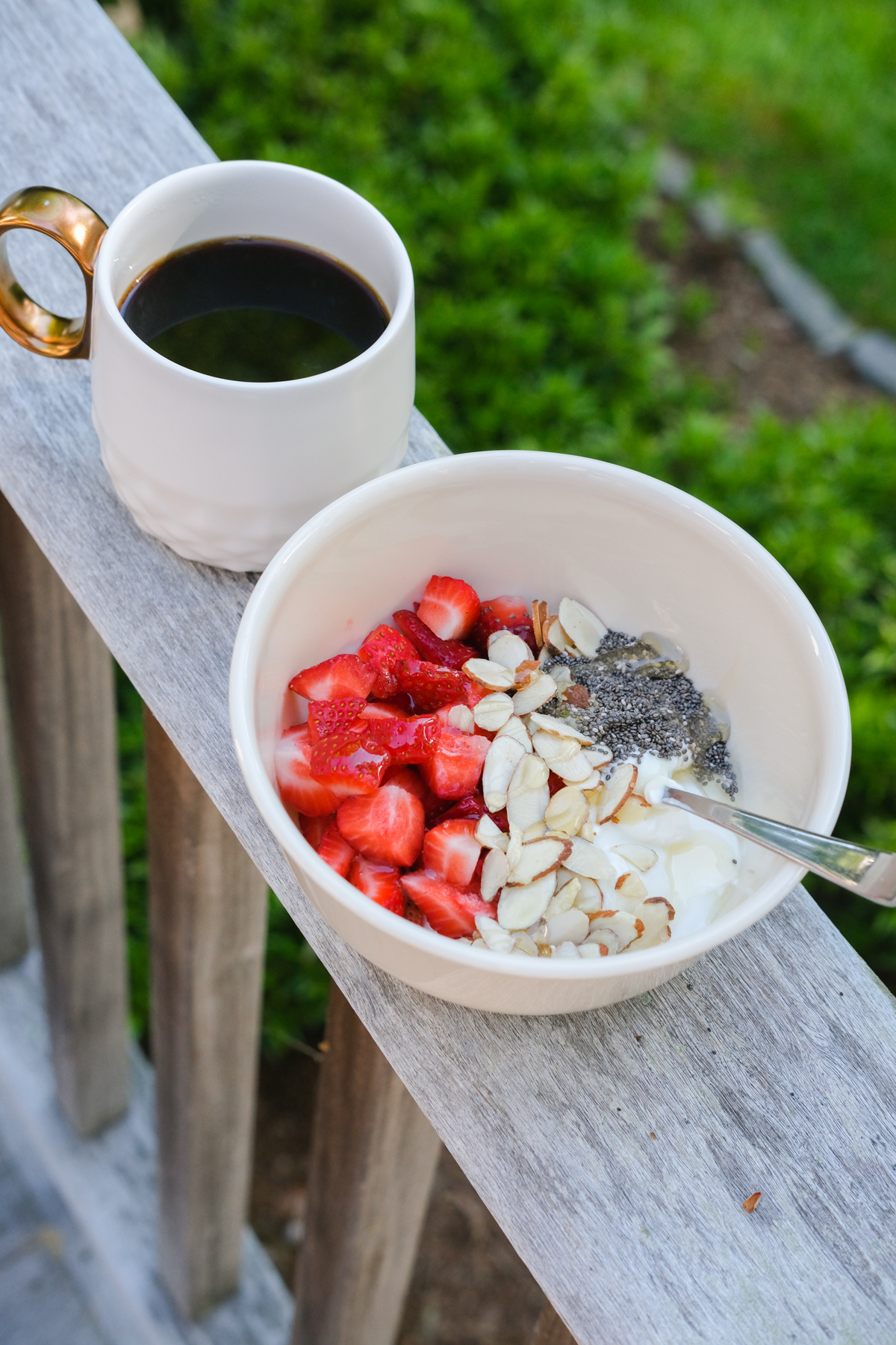 greek yogurt bowl with coffee on the porch