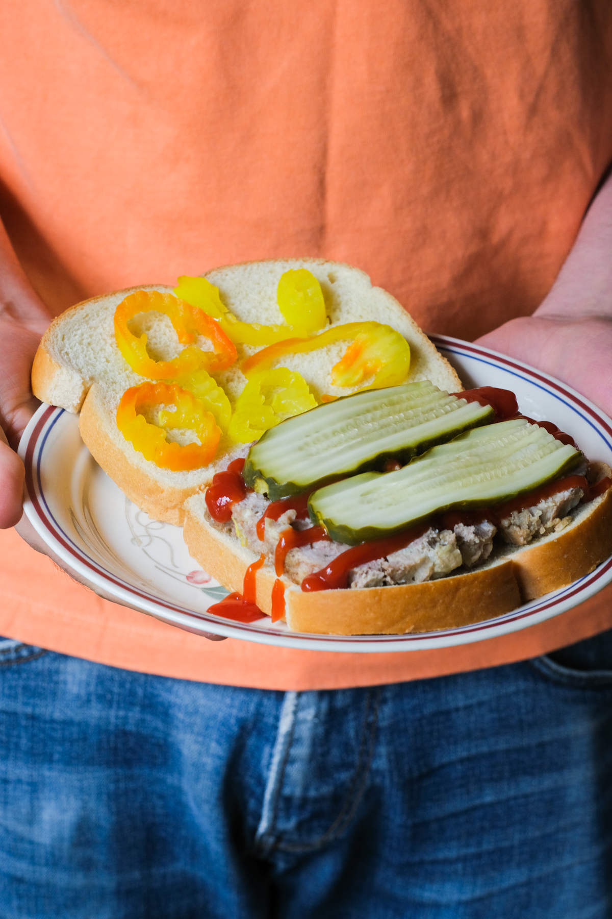 meatloaf sandwich with ketchup and pickles
