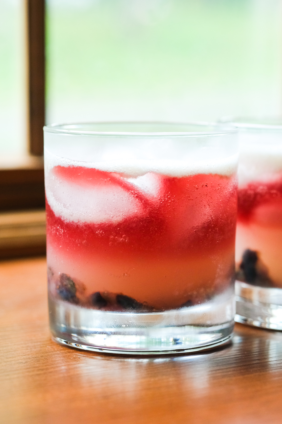 old glory cocktail with red wine float on a window sill