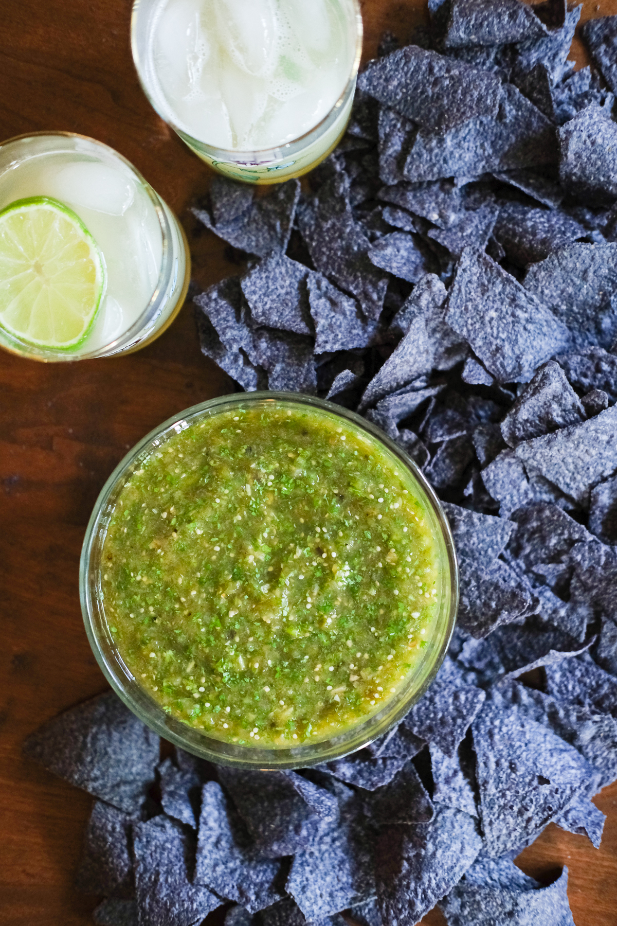 salsa verde with blue corn chips and two margaritas