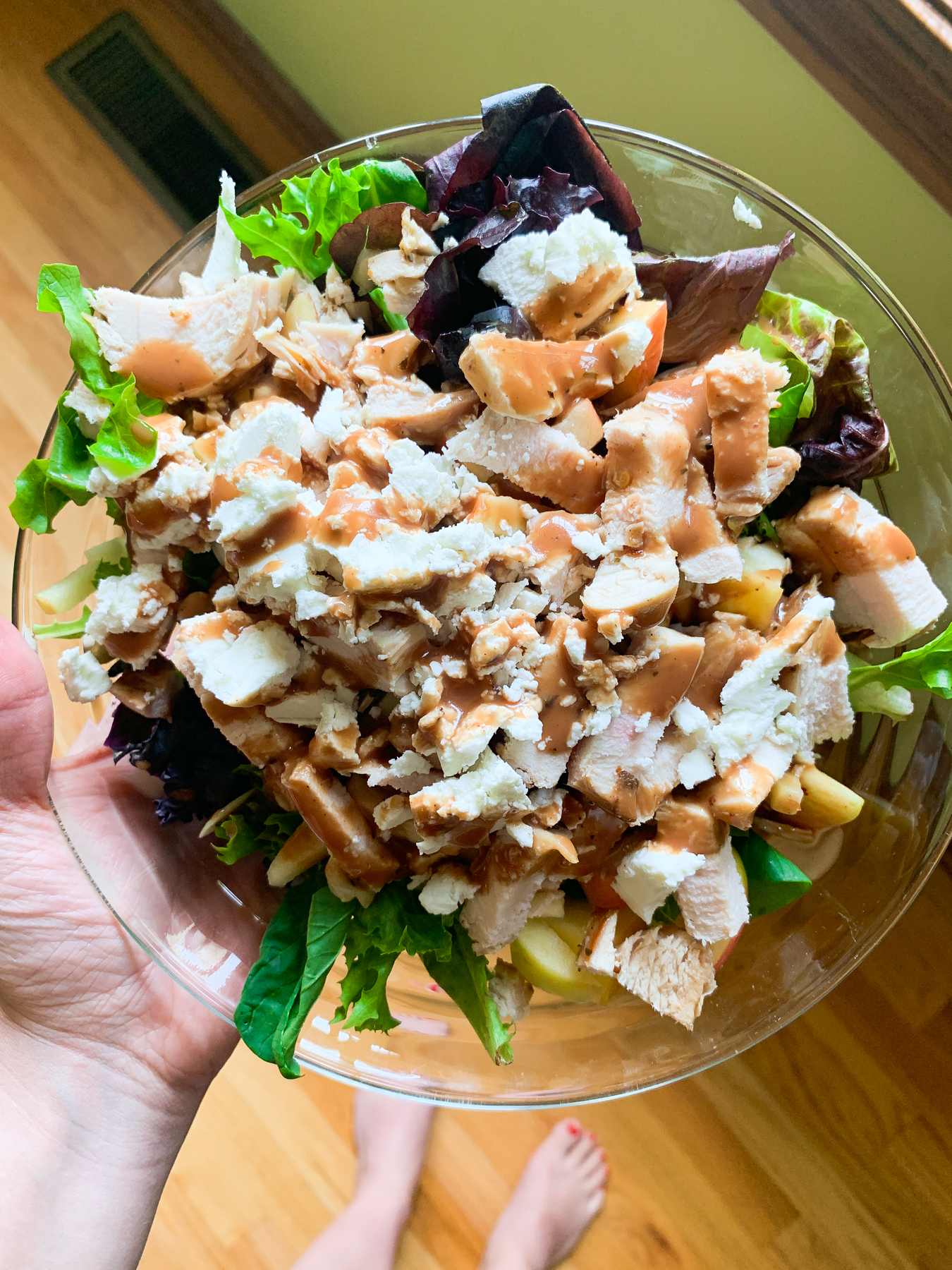 mixed green salad with apples, goat cheese, almonds, chicken, and balsamic