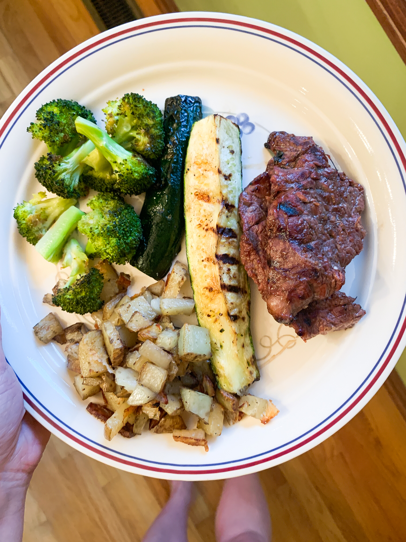 grilled steak with zucchini, roasted broccoli, and potatoes