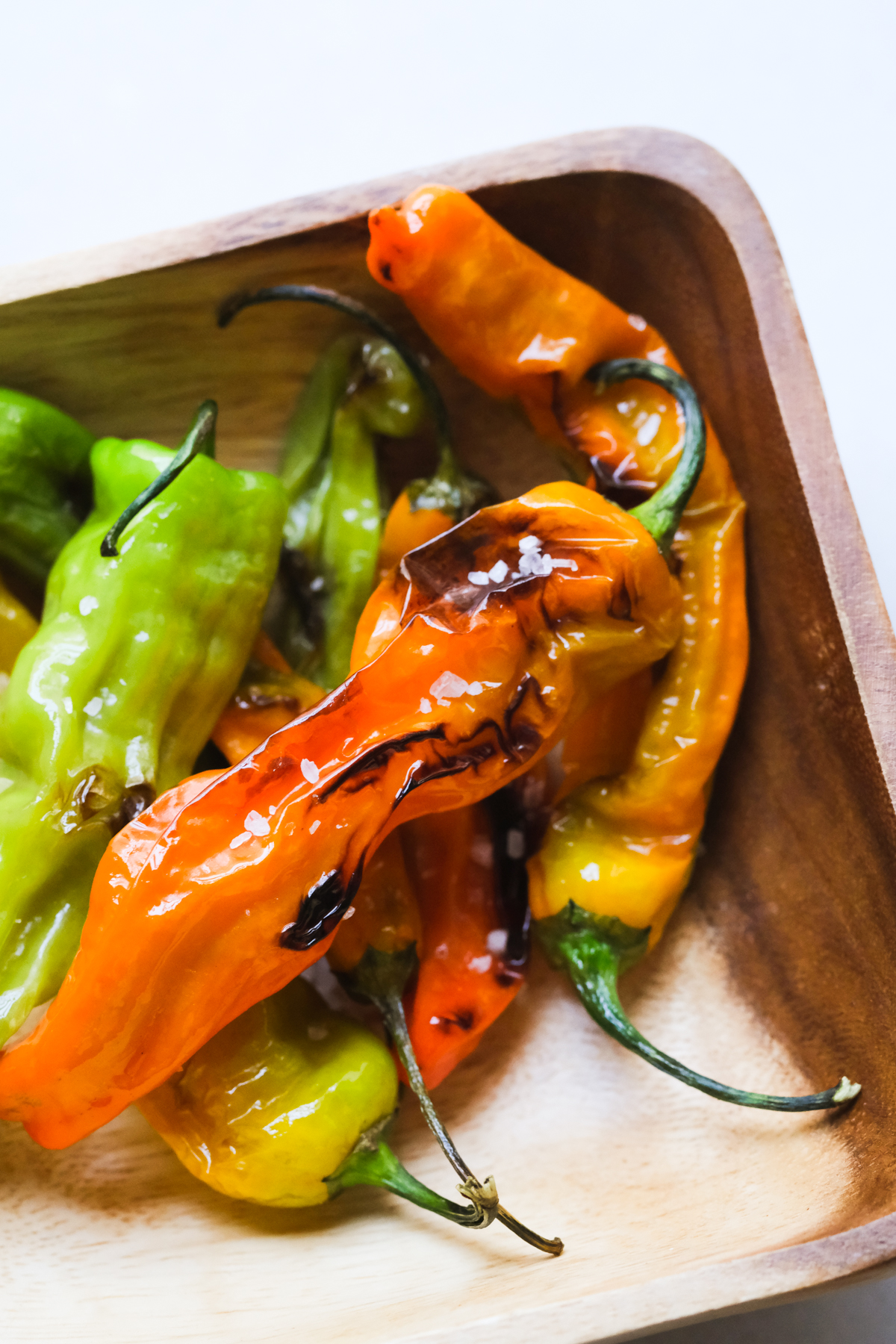blistered shishito peppers in a bowl