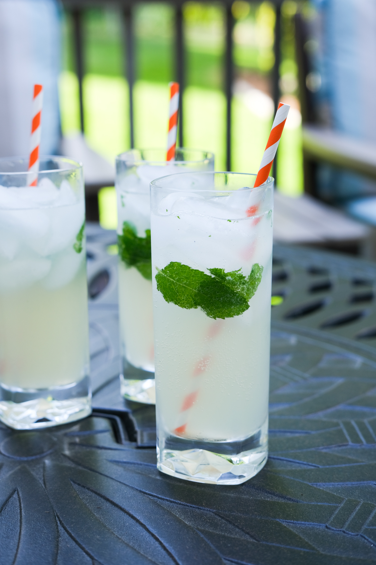 three mojitos on a table outside