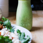 green goddess dressing in a bottle next to salad