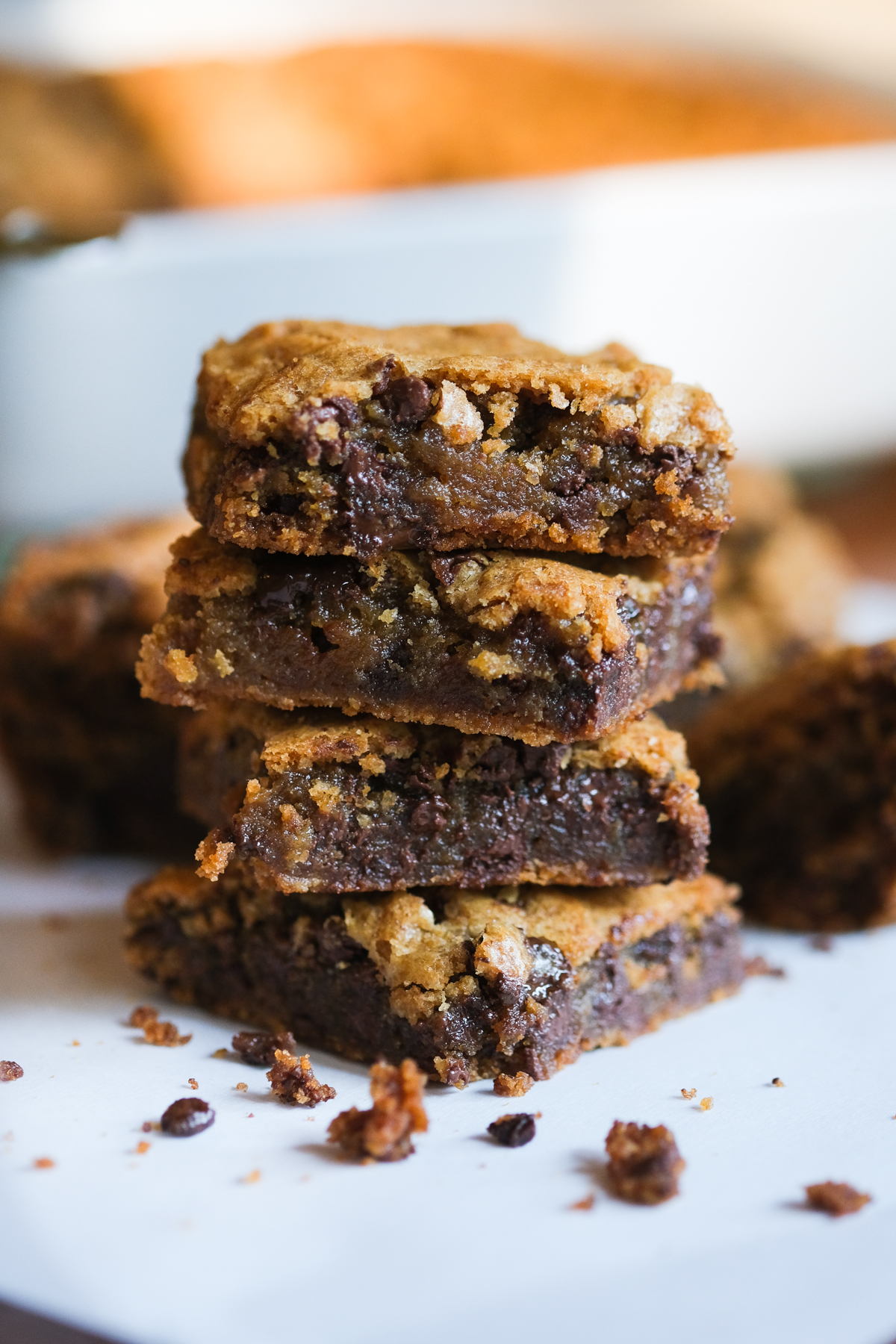 salted caramel chocolate blondies stacked up together with crumbs