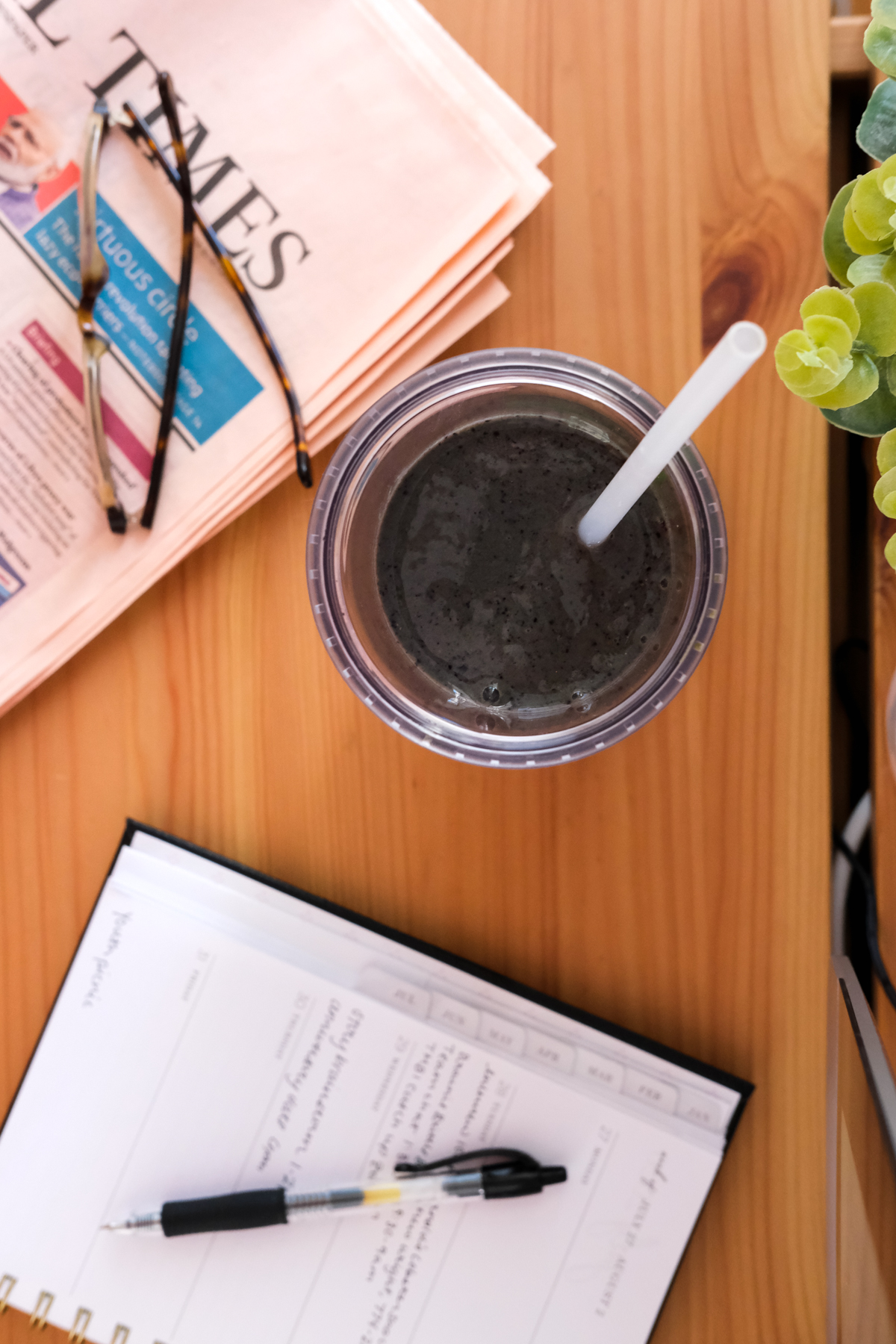 blueberry superfood smoothie on a desk