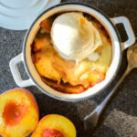 single serving peach cobbler in a small dutch oven
