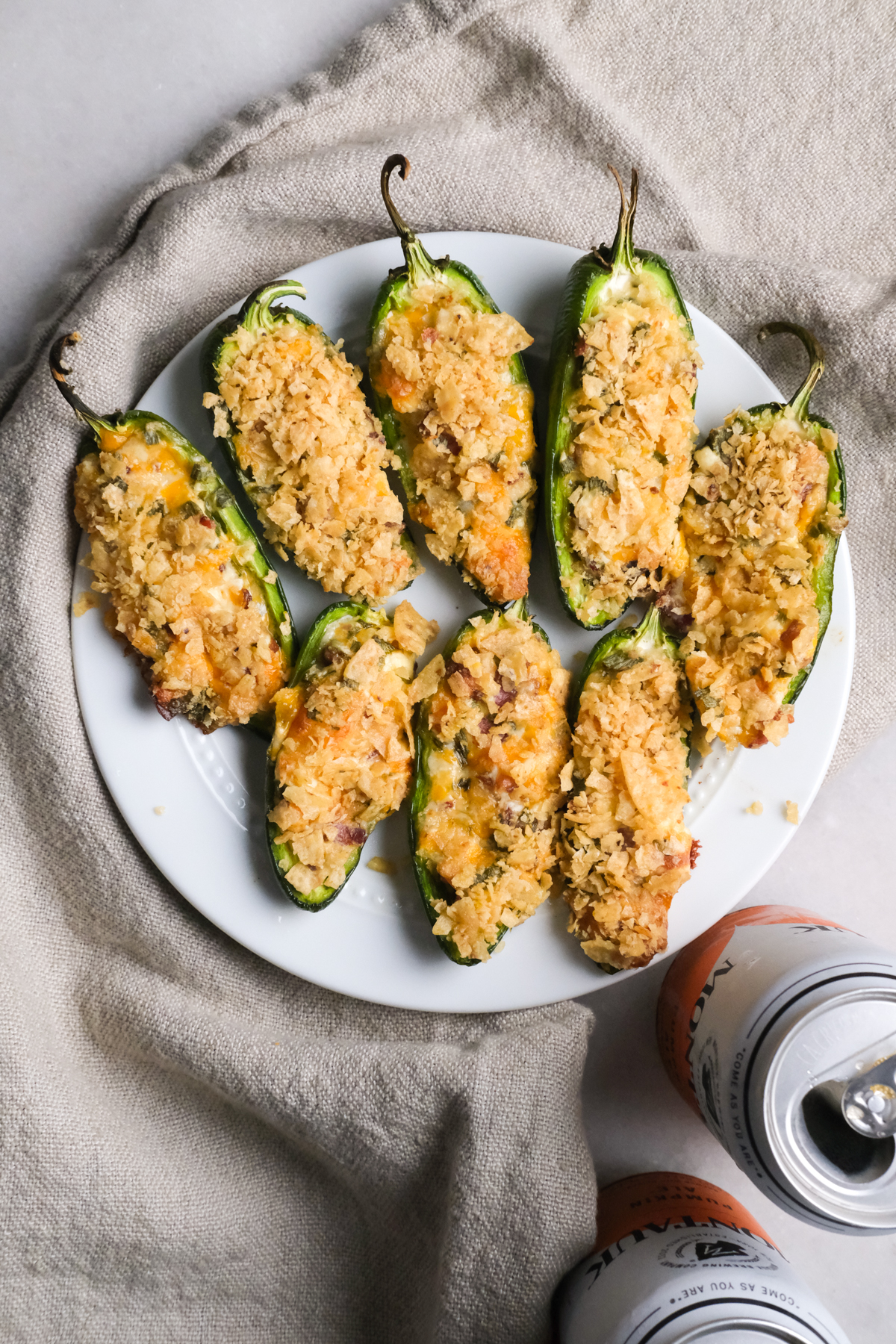 jalapeno poppers on a plate with crispy chip topping