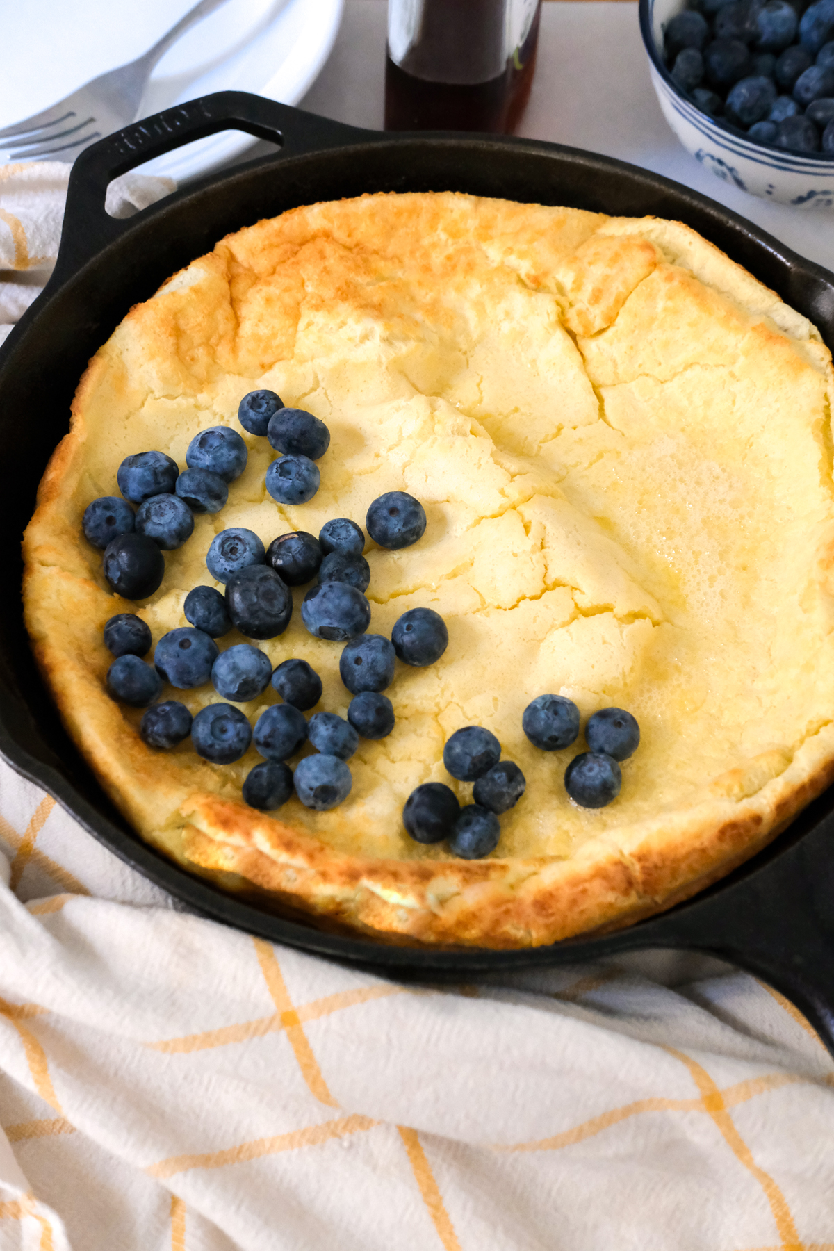 buttermilk dutch baby in a skillet with berries