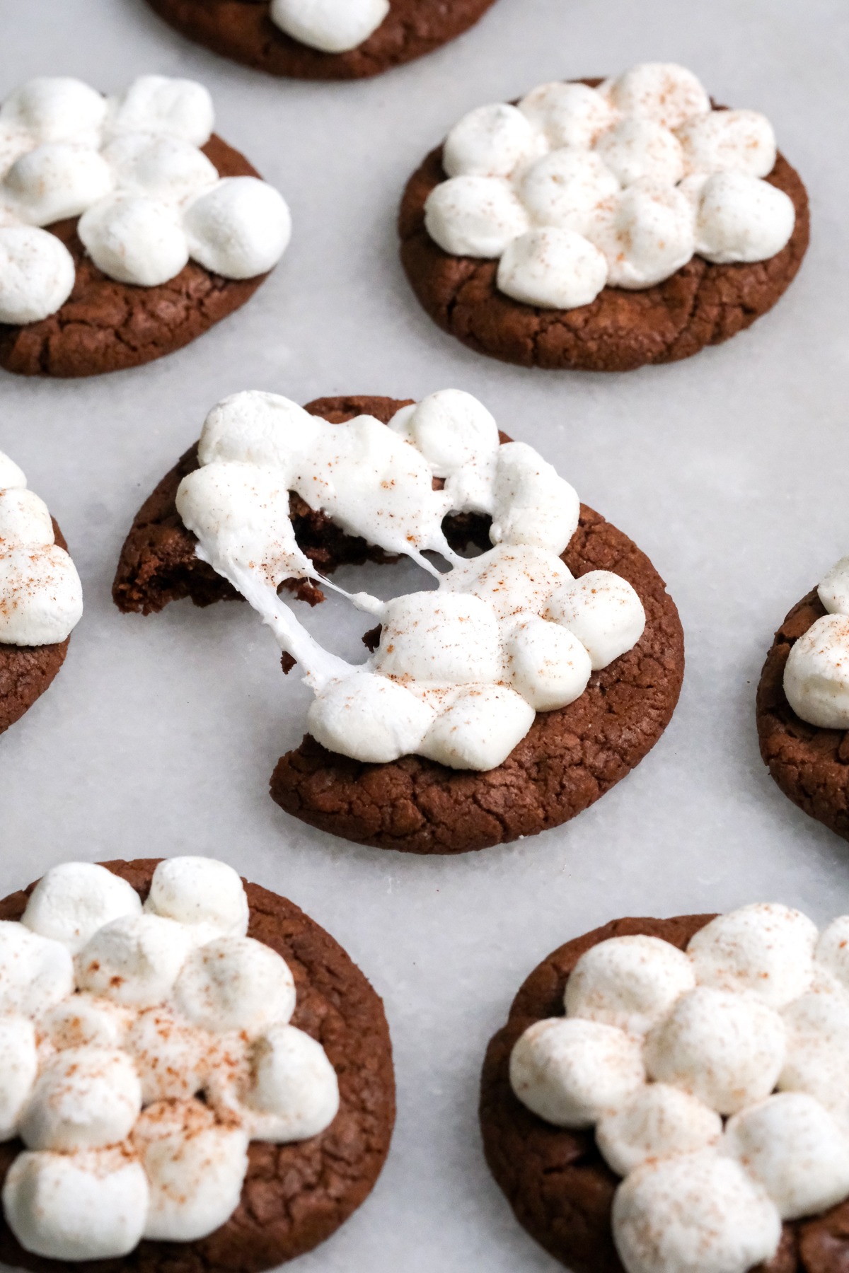 splitting a hot chocolate cookie with melted marshmallows on top