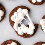 ripping apart a melty hot chocolate cookie with marshmallows