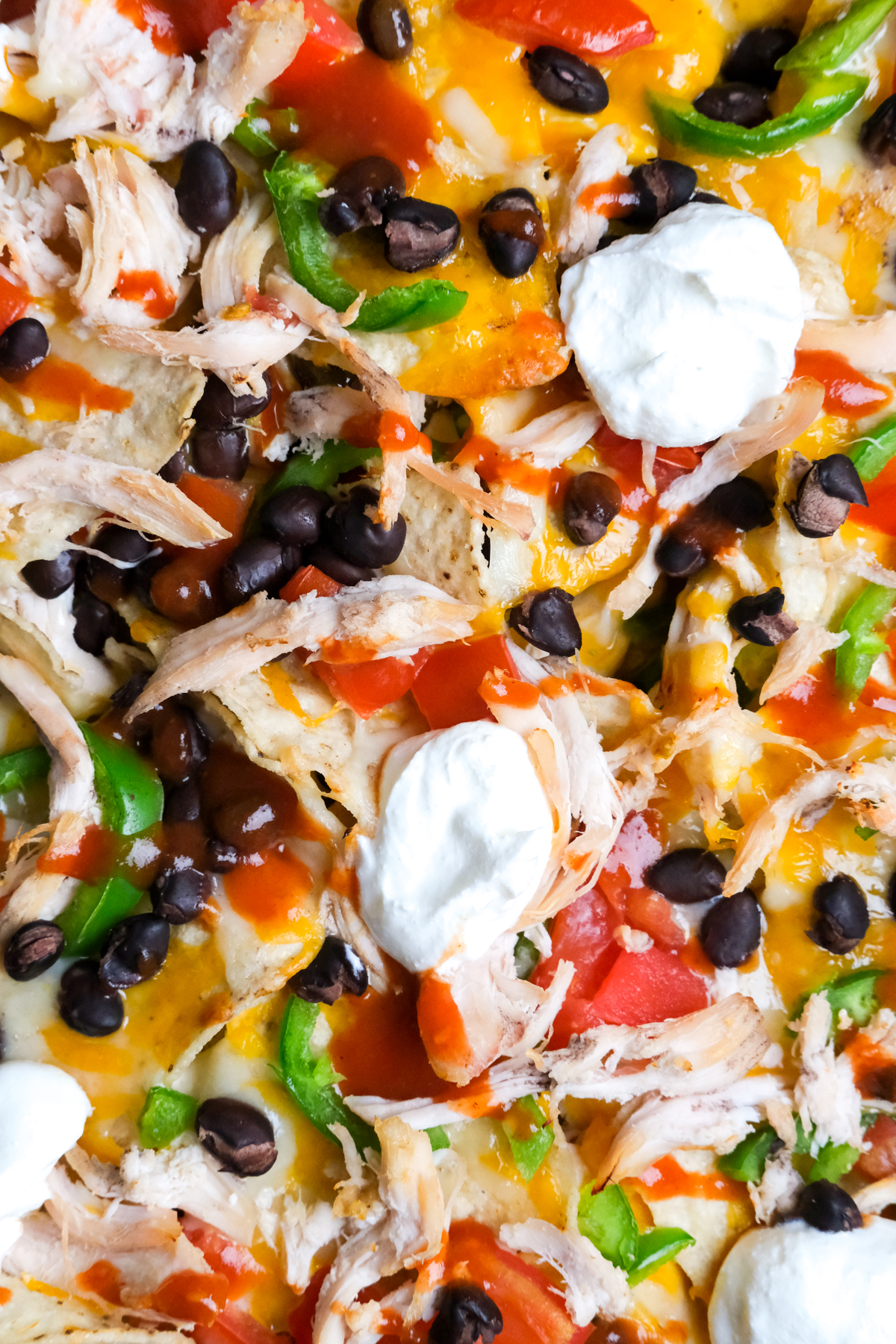 close up of fixings on chicken nachos