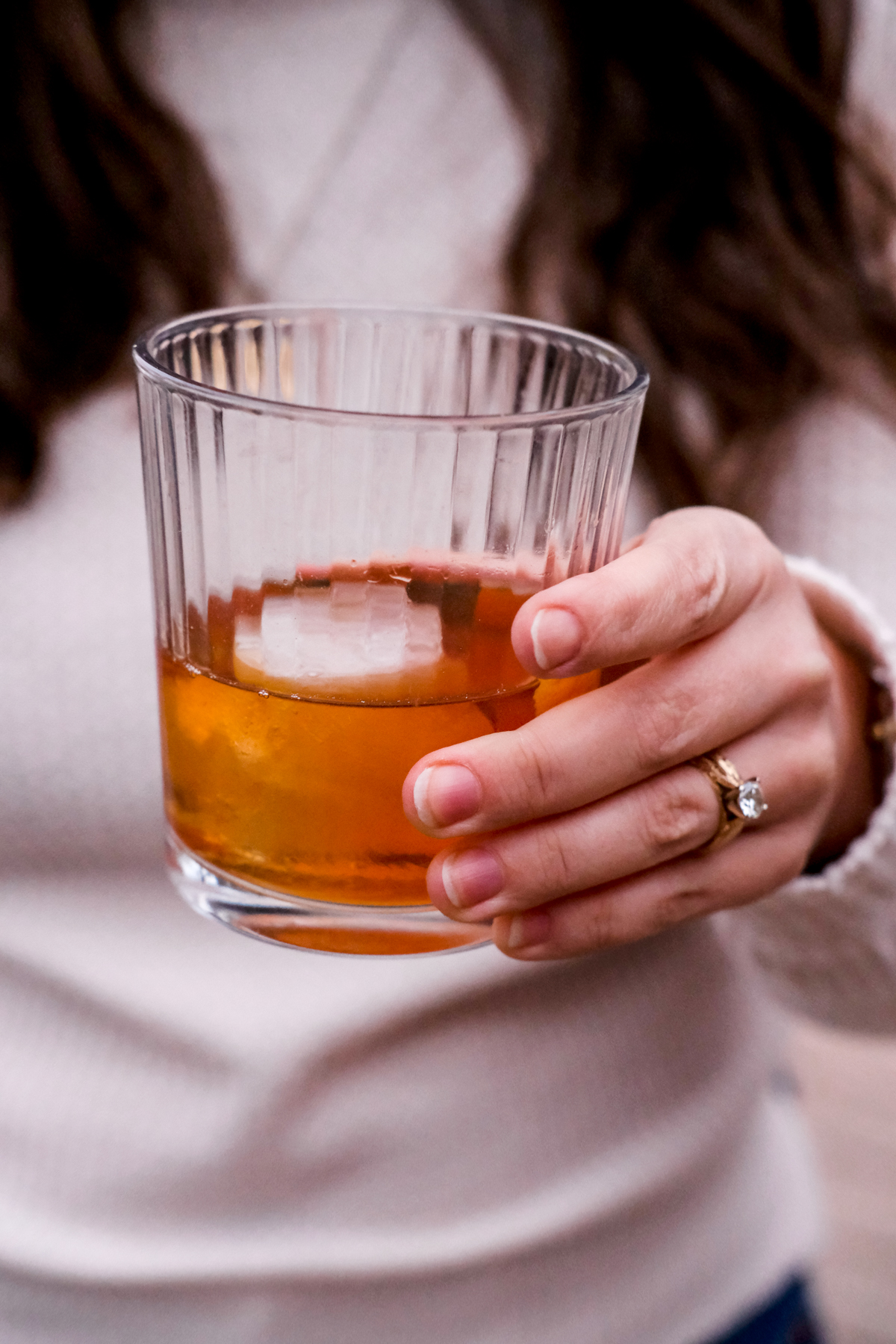 holding a classic old fashioned cocktail