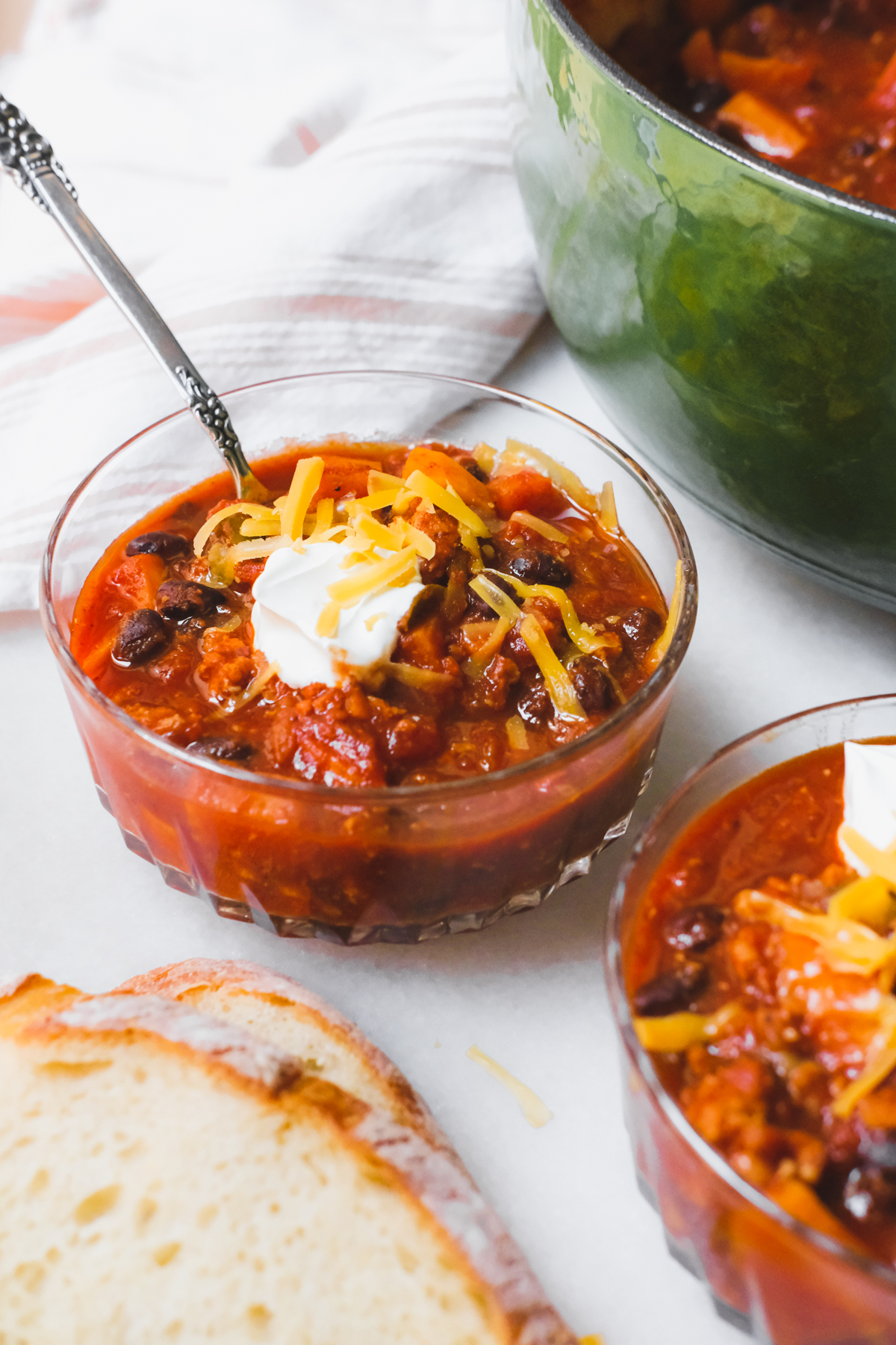 bowl of sweet potato turkey chili with sour cream and cheese