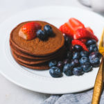 chocolate protein pancakes stacked on a plate