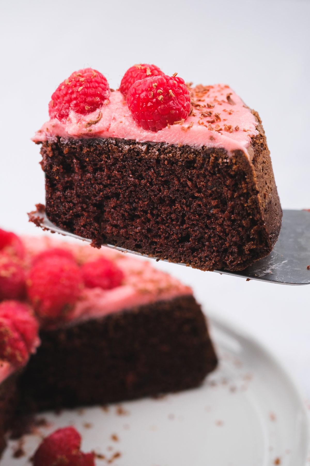 slice of chocolate raspberry cake with pink frosting