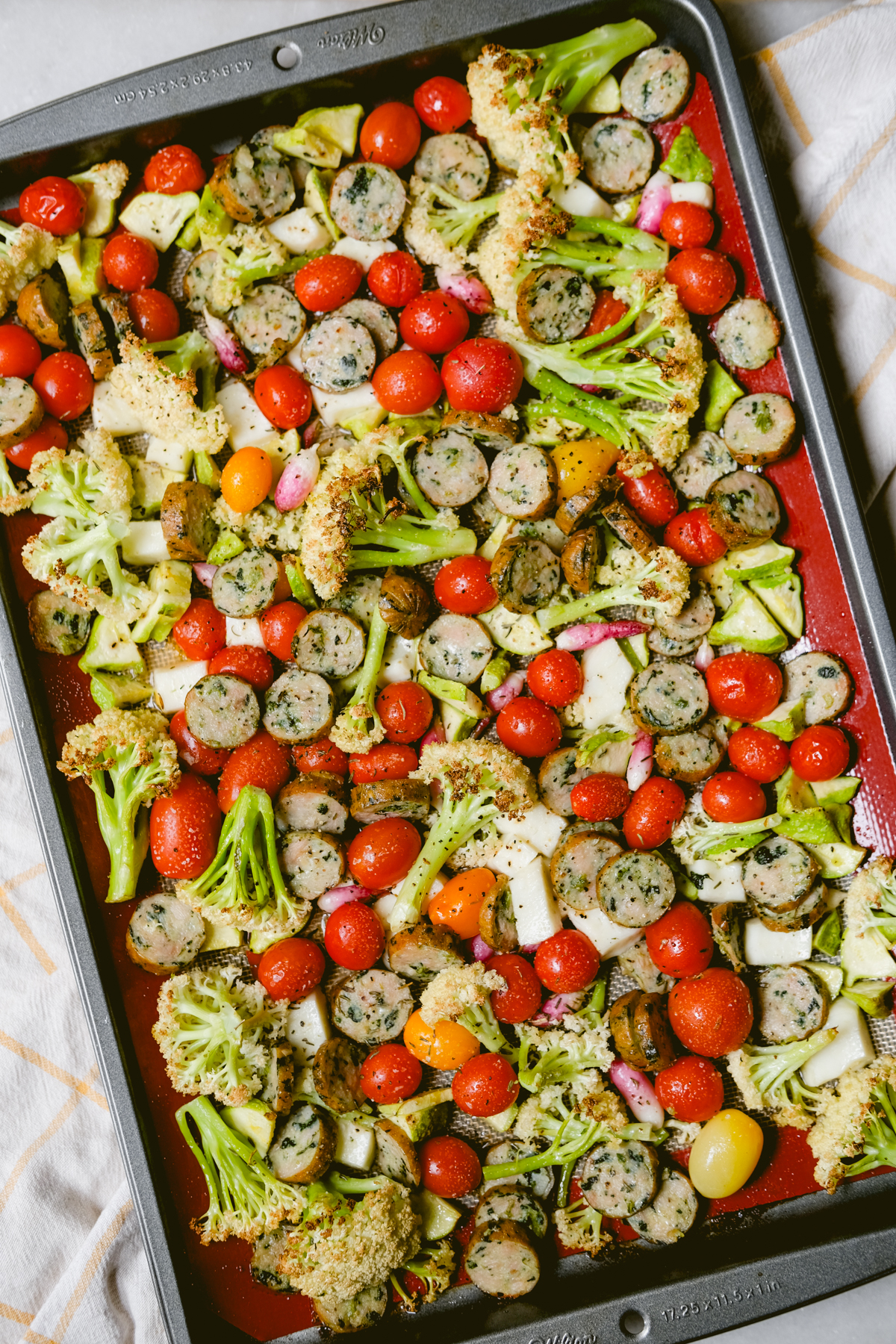 vegetables and chicken sausage roasted on a sheet pan