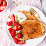slices of french toast with honey whipped ricotta strawberries and pumpkin seeds