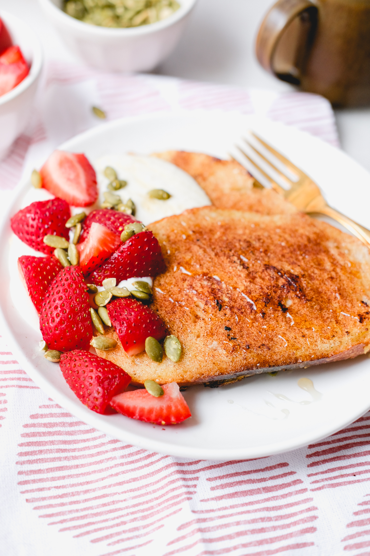 honey whipped ricotta french toast with strawberries and pepitas