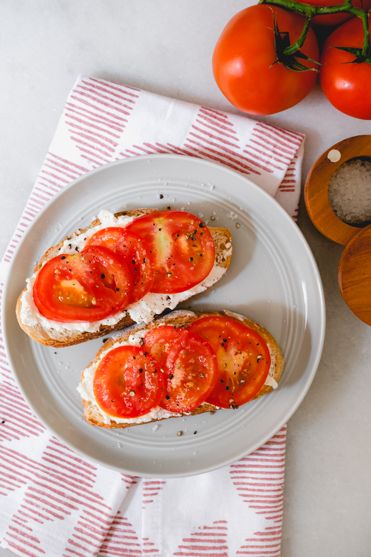 tomato ricotta toast on a grey plate