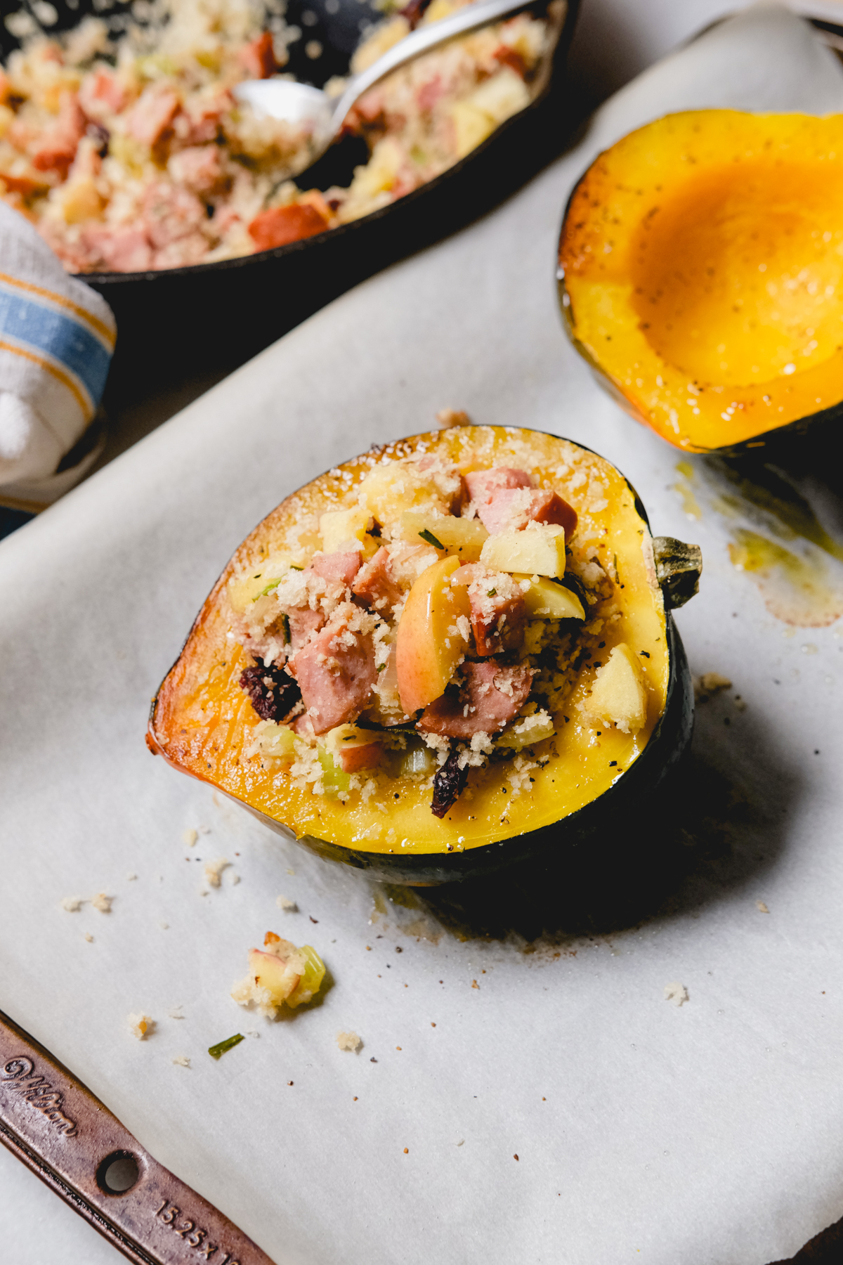 filling an acorn squash halve with chicken sausage stuffing