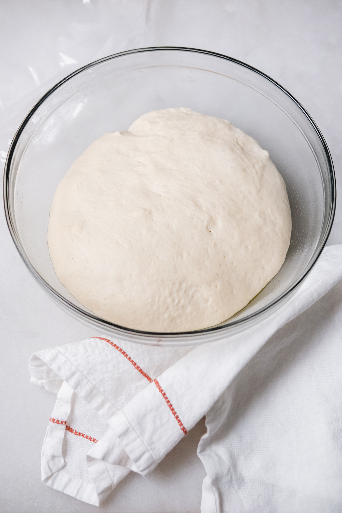 easy homemade pizza dough after the first rise in a bowl