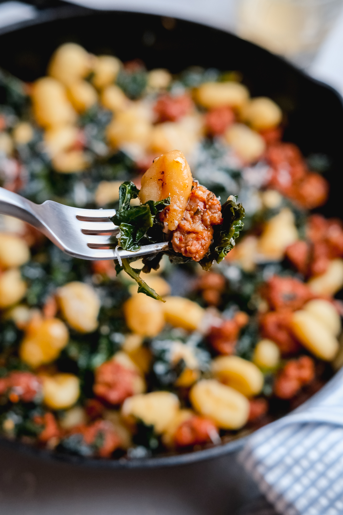 a forkful of kale gnocchi and sausage